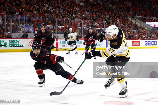 Taylor Hall of the Boston Bruins attempts a shot in Game Seven of the First Round of the 2022 Stanley Cup Playoffs against the Carolina Hurricanes at...