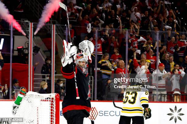 Antti Raanta of the Carolina Hurricanes celebrates their 3-2 victory as Brad Marchand of the Boston Bruins skates away f0llowing Game Seven of the...