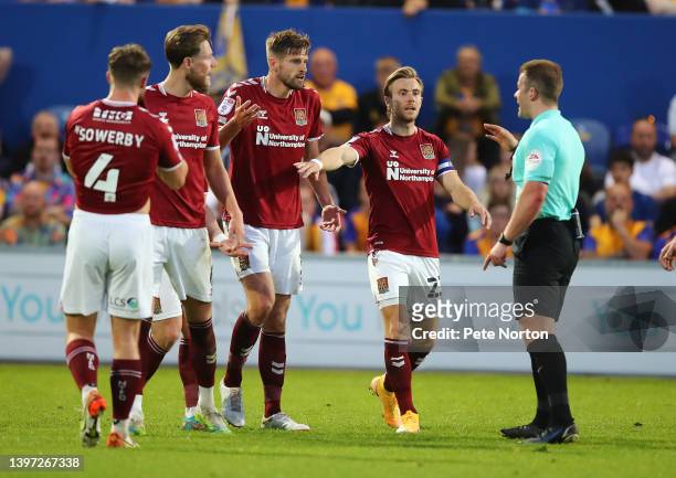 Fraser Horsfall, Jon Guthrie and Joseph Mills of Northampton Town make a point to referee Anthony Backhouse during the Sky Bet League Two Play-off...