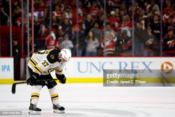 Patrice Bergeron of the Boston Bruins reacts following their 2-3 loss to the Carolina Hurricanes in Game Seven of the First Round of the 2022 Stanley...