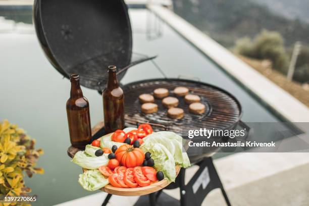 vegetarian barbecue with beers in home backyard. - backyard grilling stock-fotos und bilder