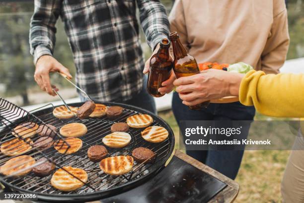 friends having barbecue in home backyard. - backyard grilling stock-fotos und bilder