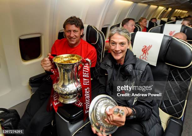 Peter Krawietz assistant manager of Liverpool and Mona Nemmer head of nutrition with the Emirates FA Cup trophy on board a flight back to Liverpool...