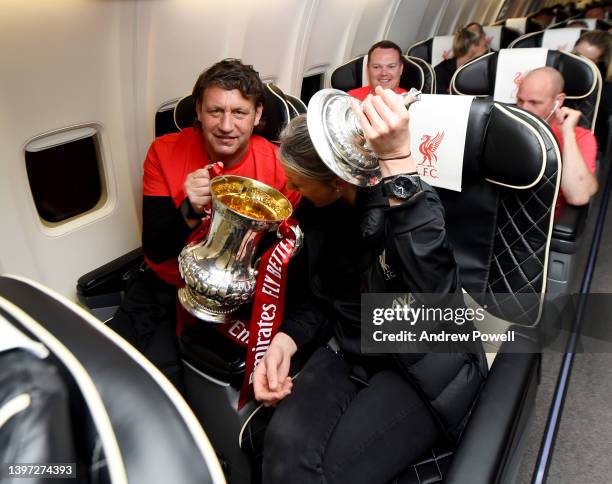 Peter Krawietz assistant manager of Liverpool and Mona Nemmer head of nutrition with the Emirates FA Cup trophy on board a flight back to Liverpool...