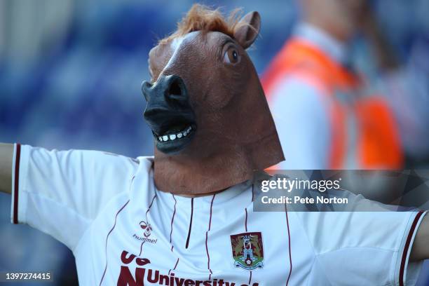 Northampton Town fan wears a horses head during the Sky Bet League Two Play-off Semi Final 1st Leg match between Mansfield Town and Northampton Town...