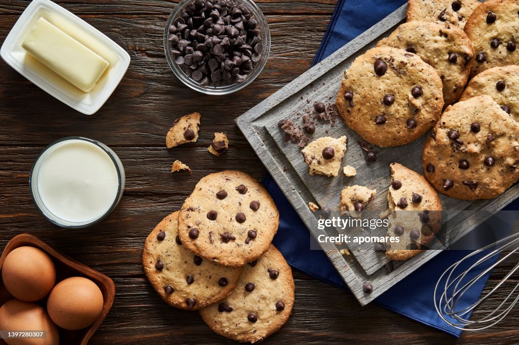 Top view of homemade chocolate chips cookies on a rustic wooden table