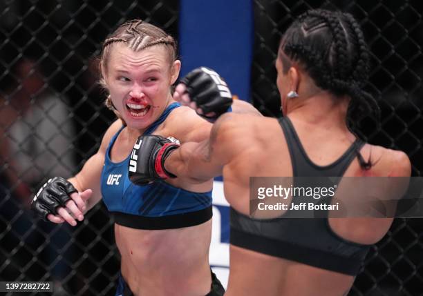 Andrea Lee punches Viviane Araujo of Brazil in a flyweight fight at UFC APEX on May 14, 2022 in Las Vegas, Nevada.