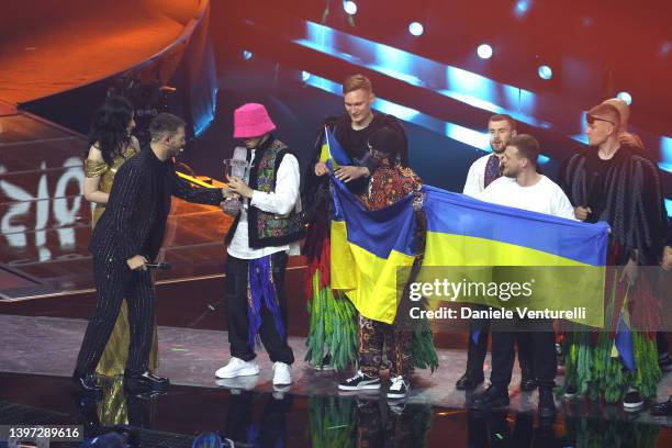 The Kalush Orchestra, representing Ukraine, receive the Eurovision Song Contest award from Alessandro Cattelan and Laura Pausini during the Grand...