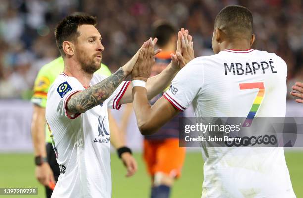 Kylian Mbappe of PSG celebrates his goal with Lionel Messi during the Ligue 1 Uber Eats match between Montpellier HSC and Paris Saint Germain at...