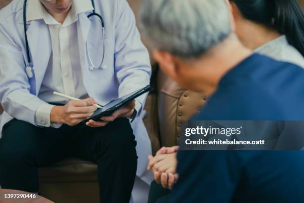 female doctor consult old couple patients in hospital - married doctor stock pictures, royalty-free photos & images