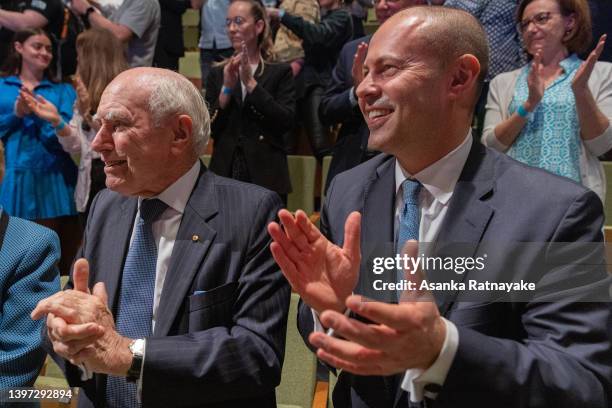 Former Australian Prime Minister John Howard and Treasurer Josh Frydenberg clap as Australian Prime Minister Scott Morrison departs the Liberal Party...