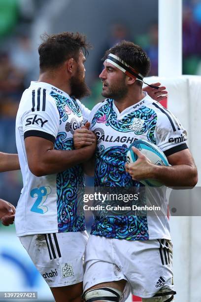 Luke Jacobson of the Chiefs is congratulated after scoring a try during the round 13 Super Rugby Pacific match between the Melbourne Rebels and the...