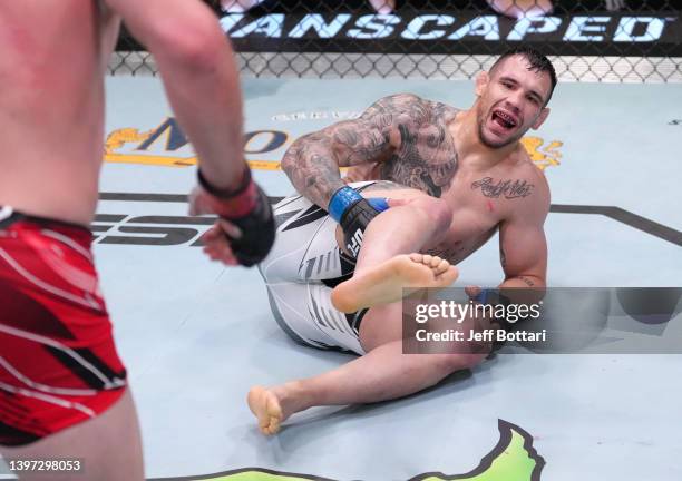 Aleksandar Rakic of Austria reacts after suffering an apparent knee injury against Jan Blachowicz of Poland in a light heavyweight fight during the...