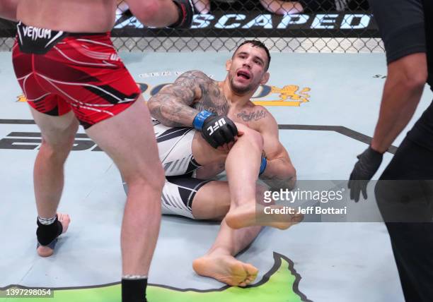 Aleksandar Rakic of Austria reacts after suffering an apparent knee injury against Jan Blachowicz of Poland in a light heavyweight fight during the...