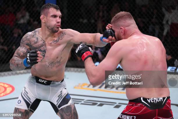 Aleksandar Rakic of Austria punches Jan Blachowicz of Poland in a light heavyweight fight during the UFC Fight Night event at UFC APEX on May 14,...