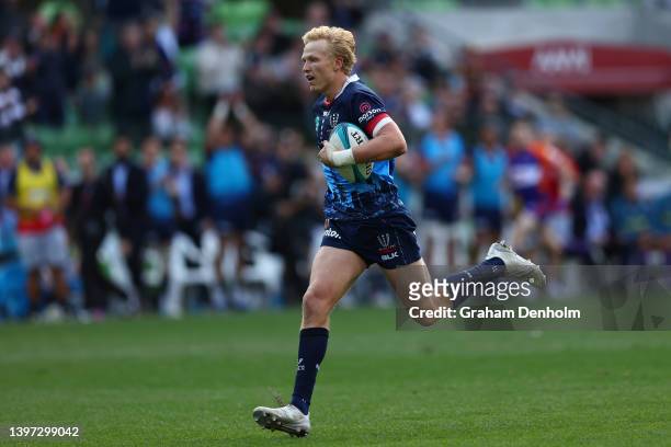 Carter Gordon of the Rebels runs in to score a try during the round 13 Super Rugby Pacific match between the Melbourne Rebels and the Chiefs at AAMI...