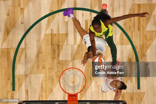 Ezi Magbegor of the Seattle Storm battles for a rebound against Skylar Diggins-Smith of the Phoenix Mercury and Diana Taurasi during the second half...