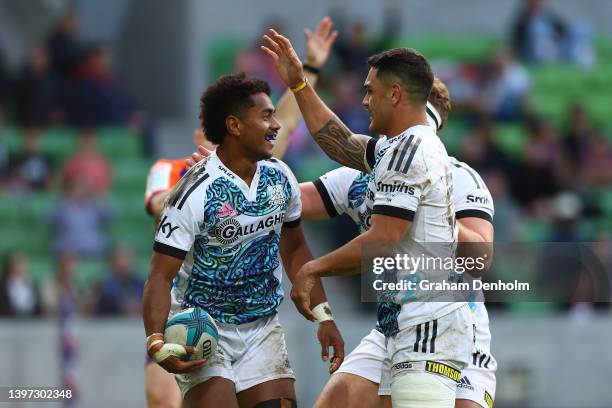 Emoni Narawa of the Chiefs is congratulated by his teammates after scoring a try during the round 13 Super Rugby Pacific match between the Melbourne...