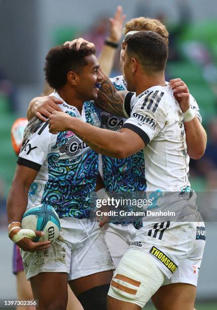 Emoni Narawa of the Chiefs is congratulated by his teammates after scoring a try during the round 13 Super Rugby Pacific match between the Melbourne...