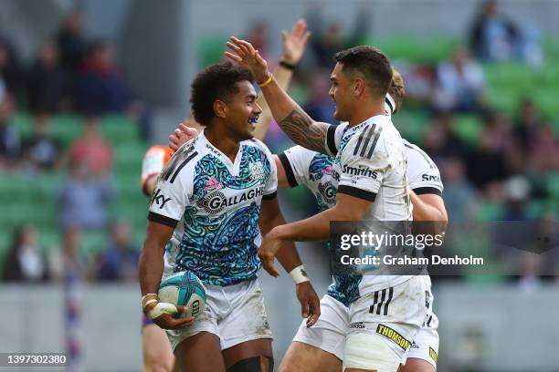 Emoni Narawa of the Chiefs is congratulated by his teammates after scoring a try during the round 13 Super Rugby Pacific match between the Melbourne...