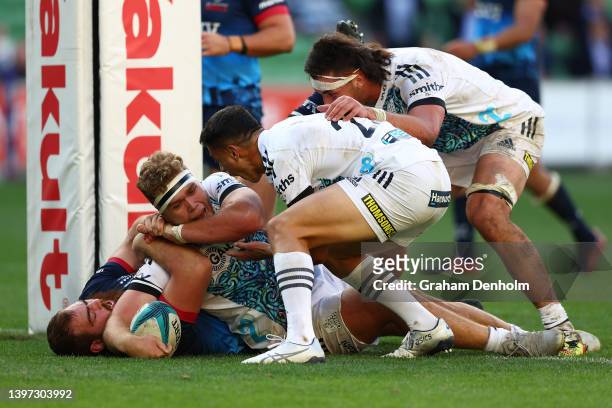 Ollie Norris of the Chiefs is congratulated by his teammates after scoring a try during the round 13 Super Rugby Pacific match between the Melbourne...