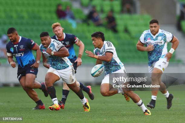 Josh Ioane of the Chiefs runs with the ball during the round 13 Super Rugby Pacific match between the Melbourne Rebels and the Chiefs at AAMI Park on...