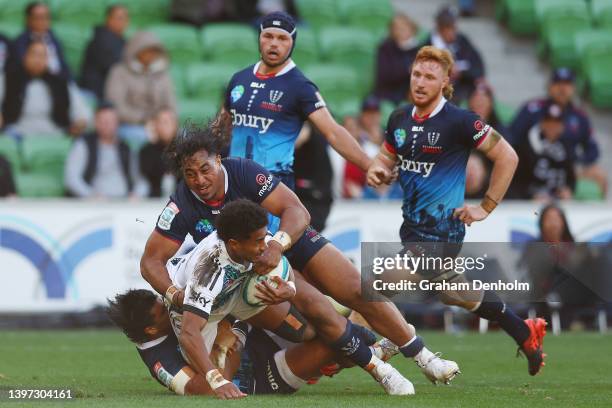 Emoni Narawa of the Chiefs is tackled during the round 13 Super Rugby Pacific match between the Melbourne Rebels and the Chiefs at AAMI Park on May...