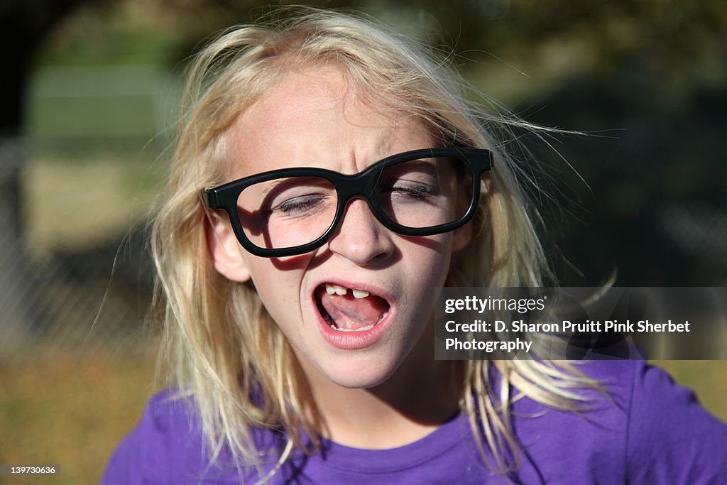 Girl wearing big glasses with goofy expression