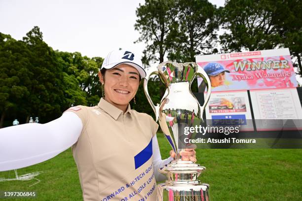Ayaka Watanabe of Japan imitates a selfie after winning the tournament following the final round of the Hoken no Madoguchi Ladies at Fukuoka Country...