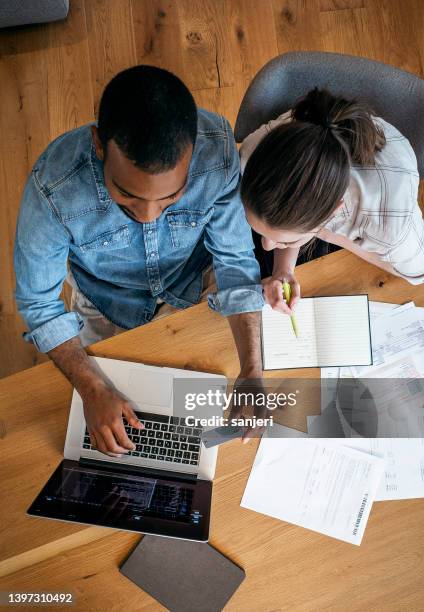 young couple planning their finances together - online bank statement stock pictures, royalty-free photos & images