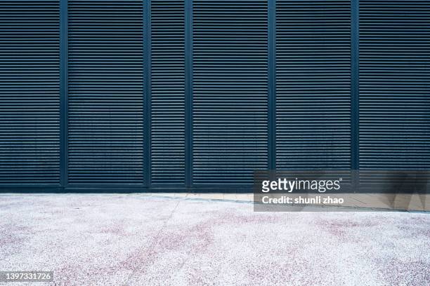 empty road against metal grate - facade blinds stock pictures, royalty-free photos & images
