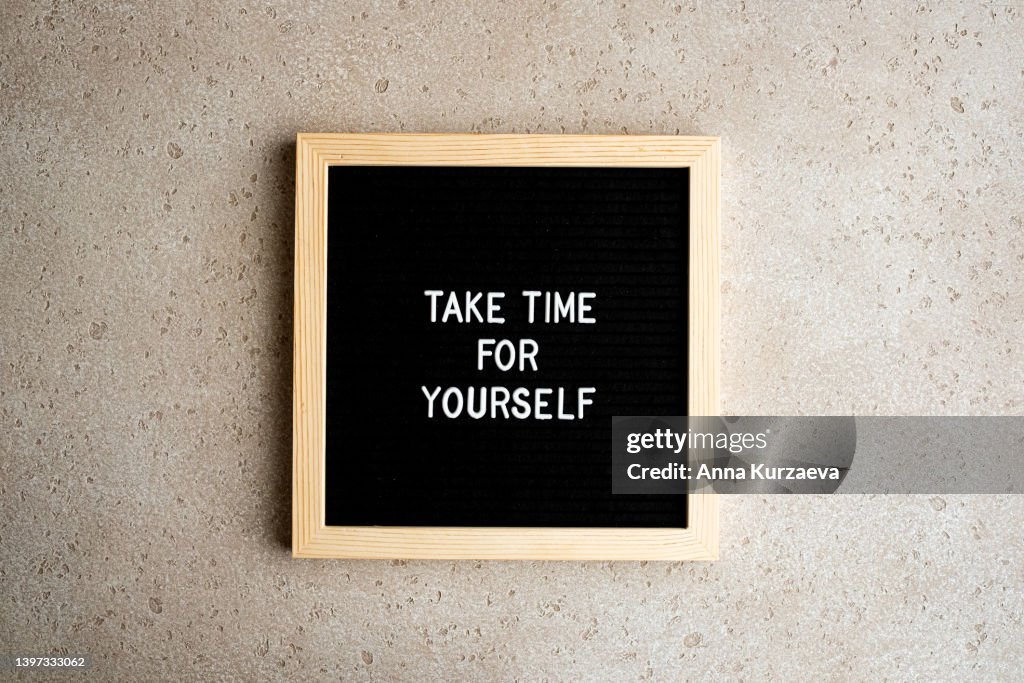 Black letter board with text “Take time for yourself” on concrete background, top view. Concept of self care.