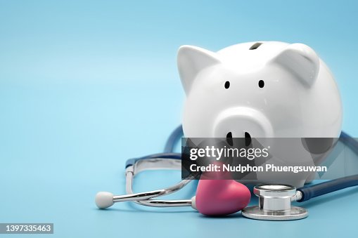 Piggy bank with stethoscope and heart isolated on light blue background with copy space. Health care financial checkup or saving for medical insurance costs concept. Piggy bank with stethoscope and heart isolated on light blue background with copy space. Health care financial checkup or saving for medical insurance costs concept.