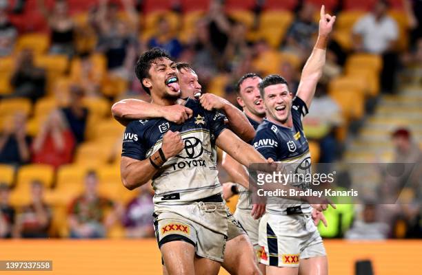 Jeremiah Nanai of the Cowboys is congratulated by team mates after scoring a try during the round 10 NRL match between the Wests Tigers and the North...