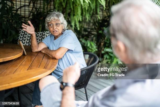 senior couple talking at home - naughty wife stock pictures, royalty-free photos & images