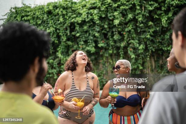 friends having a pool party at home - pool party candid stock pictures, royalty-free photos & images