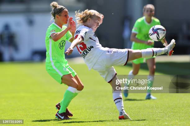 Svenja Huth of Wolfsburg challenges Caroline Siems of Leverkusen during the FLYERALARM Frauen-Bundesliga match between VfL Wolfsburg women and Bayer...