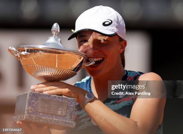 Iga Swiatek of Poland celebrates with the Internazionali BNL D'Italia Women's Singles trophy after their victory against Ons Jabeur of Tunisia during...