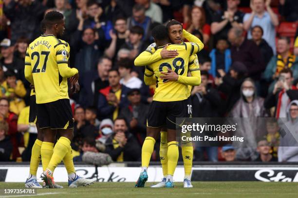 Joao Pedro of Watford FC celebrates their sides first goal with team mate Samuel Kalu during the Premier League match between Watford and Leicester...