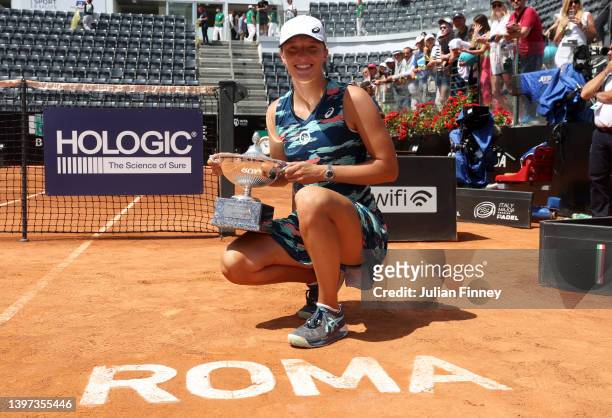 Iga Swiatek of Poland celebrates with the Internazionali BNL D'Italia Women's Singles trophy after their victory against Ons Jabeur of Tunisia during...