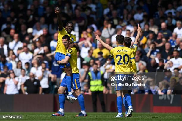 Lewis Dunk lifts Danny Welbeck of Brighton & Hove Albion whilst celebrating scoring their side's first goal with teammates during the Premier League...