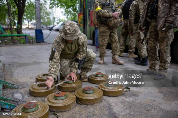 Ukrainian soldier deactivates anti tank mines before repositioning them to the frontline closer to Russian troops on May 15, 2022 in Kharkiv,...
