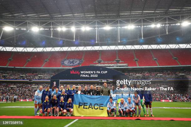 Chelsea and Manchester City players hold a Ukrainian flag to indicate peace and sympathy with Ukraine prior to the Vitality Women's FA Cup Final...