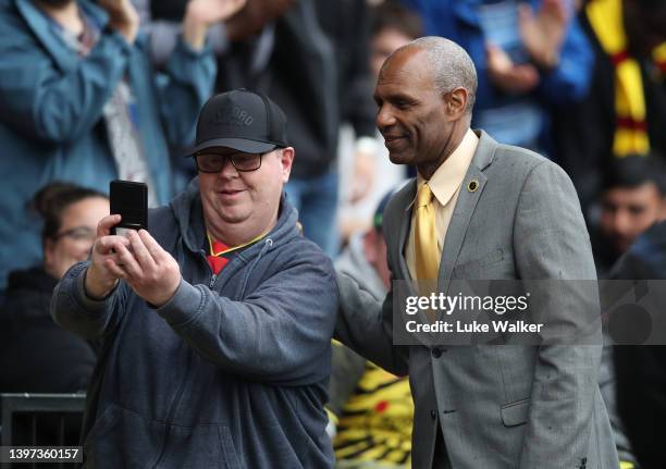 Former Watford FC Footballer Luther Blissett poses for a photo with a fan during the Premier League match between Watford and Leicester City at...