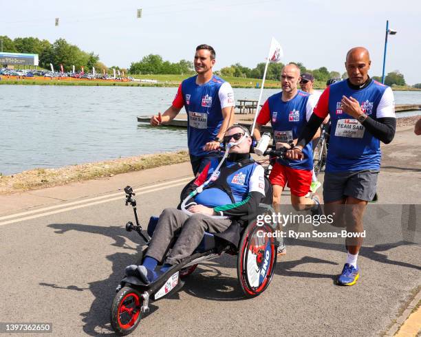 Team of Nottingham Forest staff and ex-players consisting of Simon Fotheringham, Jack Hobbs, Jason Lee push Forest fan Sam Perkins from East Leake in...