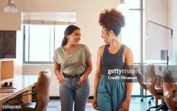 beautiful mixed race creative business woman chatting with a female colleague. two young female african american designers talking in the office. meeting to discuss and develop a strategy for success - employee leaving stock pictures, royalty-free photos & images