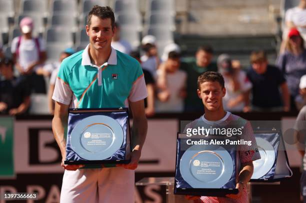 John Isner of the United States and Diego Schwartzman of Argentina pose for a photo with the Internazionali BNL D'Italia runners up trophy after...