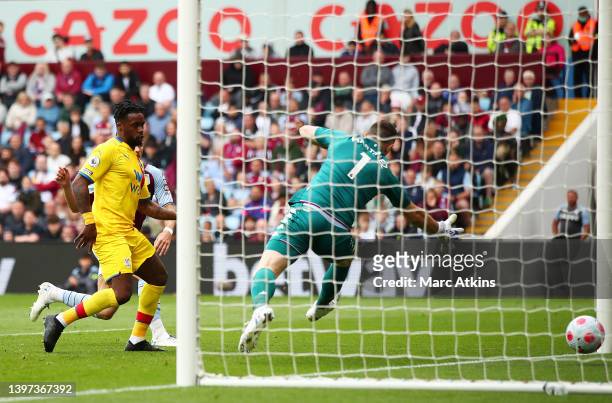 Emiliano Martinez of Aston Villa looks on as Jeffrey Schlupp of Crystal Palace scores their side's first goal during the Premier League match between...