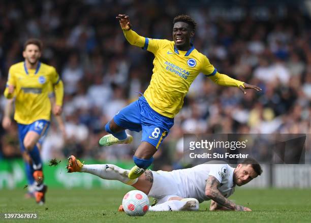 Yves Bissouma of Brighton & Hove Albion is fouled by Liam Cooper of Leeds United during the Premier League match between Leeds United and Brighton &...
