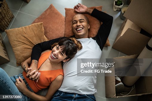 Happy young couple lying on the floor at new home Happy young couple lying on the floor at new home